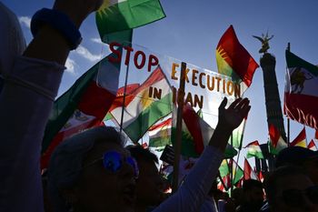 Protesters hold up a placard reading 'Stop Execution in Iran' during a rally in support of the anti-regime Iranian protests, in Berlin, Germany.