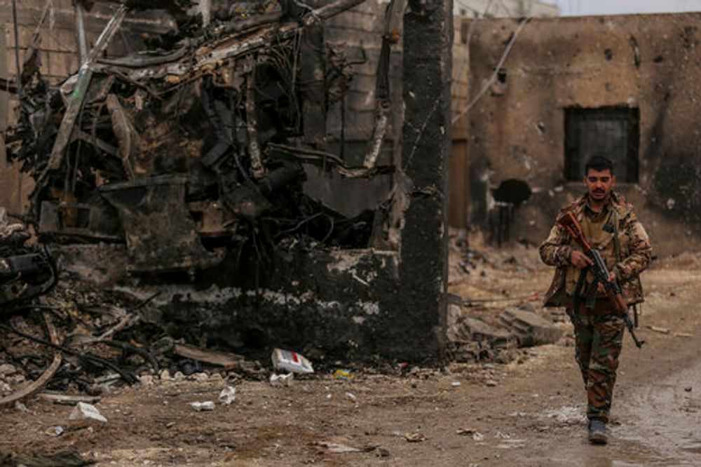 A Syrian soldier keeps watch by a prison that was attacked by Islamic State militants in Hassakeh, Syria, February 8, 2022.