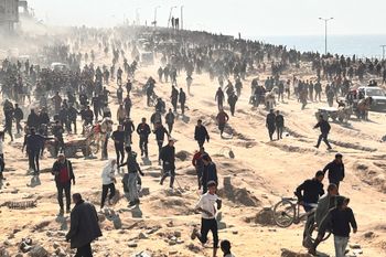 FILE - Palestinians wait for humanitarian aid on a beachfront in Gaza City, Gaza Strip, February 25, 2024.