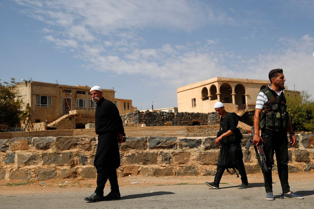 Young Druze armed men patrol the village of Rami in the southern province of Sweida, Syria, on October 4, 2018.