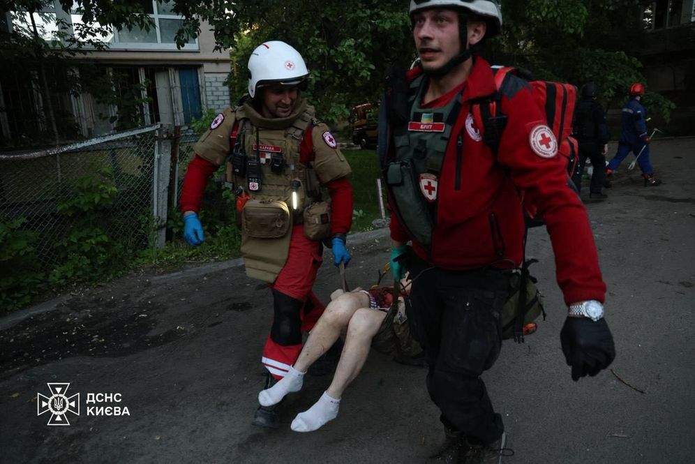 State Emergency Service of Ukraine Rescue service members evacuate a person to safety in the aftermath of Russian strikes on Ukraine