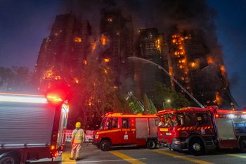 Firefighters work to extinguish a fire which broke out at Wang Fuk Court, a residential estate in the Tai Po district of Hong Kong's New Territories, Wednesday, Nov. 26 2025