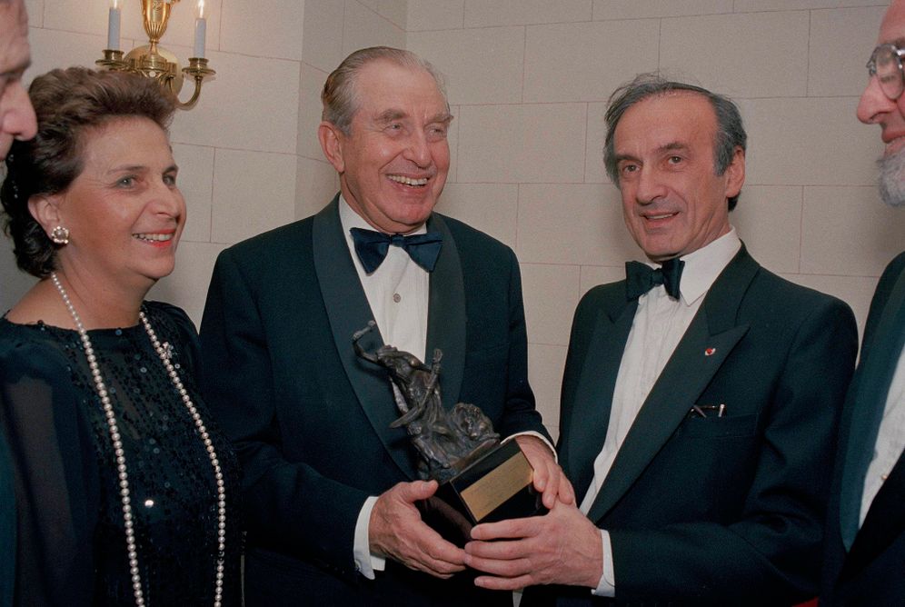 Aura Herzog, pictured far left, with her husband, then Israeli president Chaim Herzog, center, as Nobel laureate Elie Wiesel presents him with an award at New York's Waldorf Astoria, November 14, 1987.
