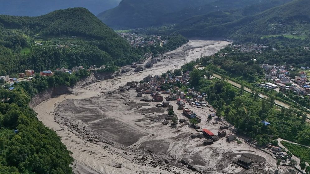 AP Photo/Niranjan Shrestha בתים פגועים עומדים במצב מסוכן ליד גדות נהר טרישולי הנפוחות והחנוקות בהריסות לאחר שיטפונות פתאומיים במחוז נואקוט בנפאל ביום רביעי, 26 באוגוסט 2026