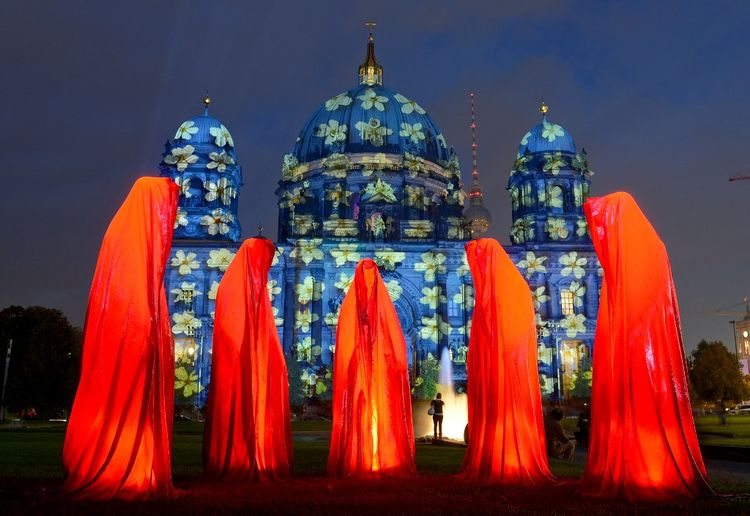 The installation "Guardians of Time" by Austrian artist Manfred Kielnhofer is seen in front of the enlightened Berlin Cathedral in Germany, on October, 9 2013.