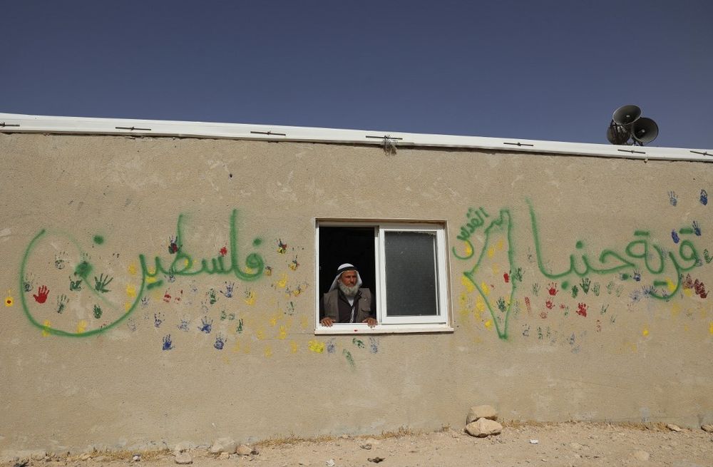 Ali Mohammed Jabbareen stands at the window of his house in the Palestinian village of Jinba, part of Masafer Yatta in the West Bank, on May 9, 2022.