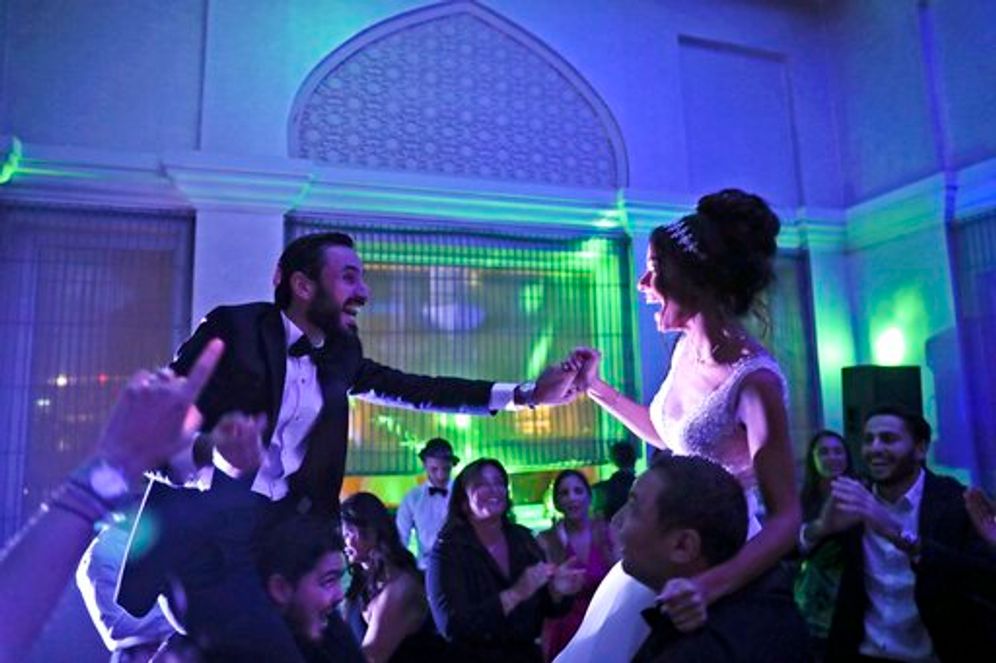 An Israeli couple grasp hands during their wedding party in Dubai, United Arab Emirates, on December 17, 2020.