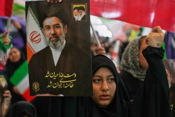 A woman holds a portrait of Iran's Supreme Leader, Ayatollah Mojtaba Khamenei, during a ceremony honoring the armed forces and those killed in the war with Israel and the U.S. at the Imam Khomeini Grand Mosque in Tehran, Iran, Sunday, May 24, 2026. 
