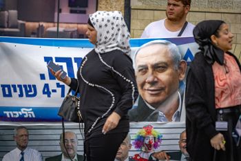 People walk past election posters  for the upcoming elections in Jerusalem, Israel on October 24, 2022.