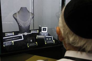 A buyer looks at jewelry during the International Diamond Week in the Israeli town of Ramat Gan, east of Tel Aviv,