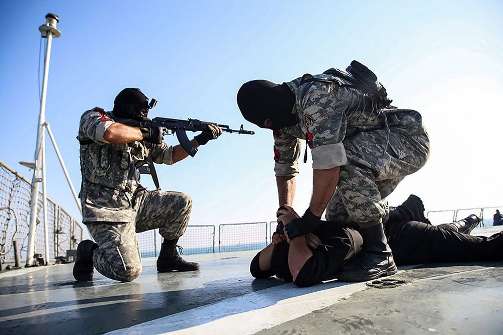 Revolutionary Guards Corps and Russian soldiers taking part in a drill simulating capturing a hijacked ship, during joint naval drills in the Indian Ocean, February 17, 2021.