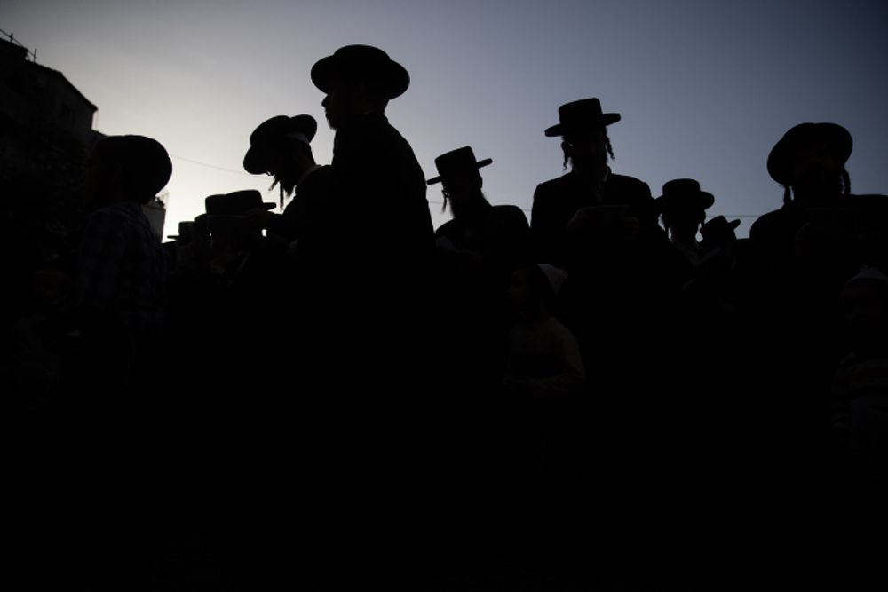 Ultra-Orthodox Jews attend a mass prayer in memory of those killed during a stampede at a Lag b'Omer event in the Northern Israeli city of Meron, on May 6, 2021.