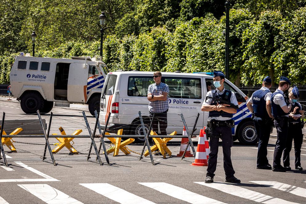 AP Photo/Valentin Bianchi Police officers stand guard next to a security perimeter set around the US embassy during a NATO summit in Brussels, Monday, June 14, 2021