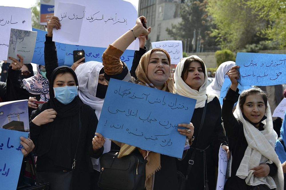 Afghan women and girls take part in a protest in front of the Ministry of Education in Kabul, Afghanistan, demanding that high schools be reopened for girls on March 26, 2022.