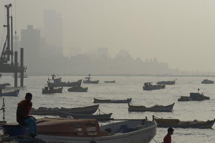 Boats are see anchored near the sea front during a hazy afternoon in Mumbai, India, on January 6, 2021.