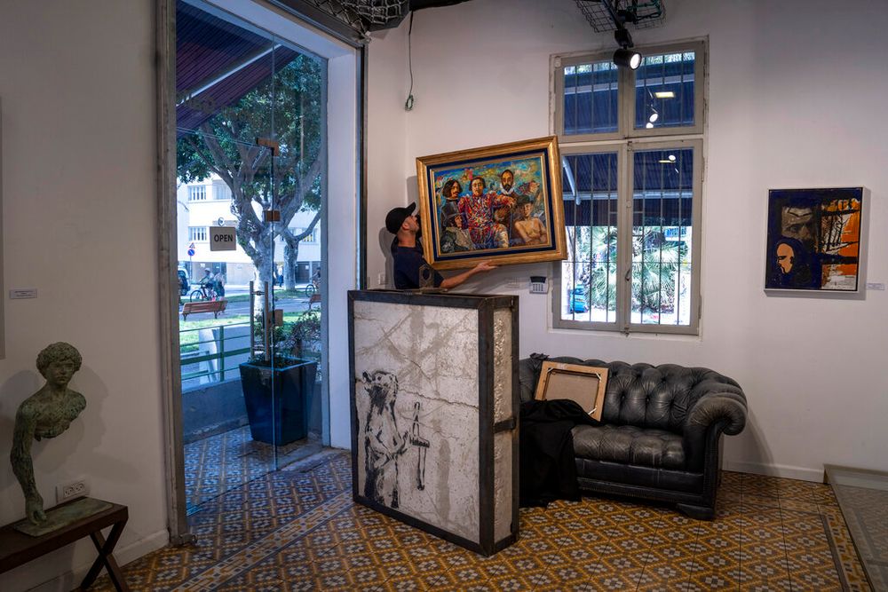 A painting by the British graffiti artist Banksy that was mysteriously transferred from the West Bank is revealed in the Urban Gallery in Tel Aviv, Israel, on August 4, 2022.