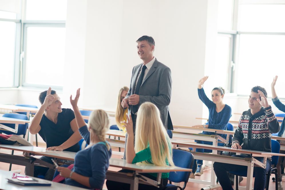 Group Of Students With Teacher On Class
