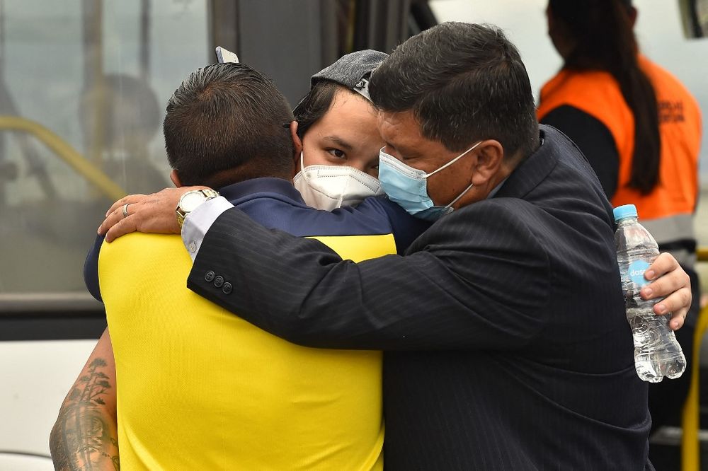 An Ecuadorean who fled from Ukraine is greeted by relatives upon arrival at Quito's Mariscal Sucre airport, in Ecuador, on March 4, 2022.