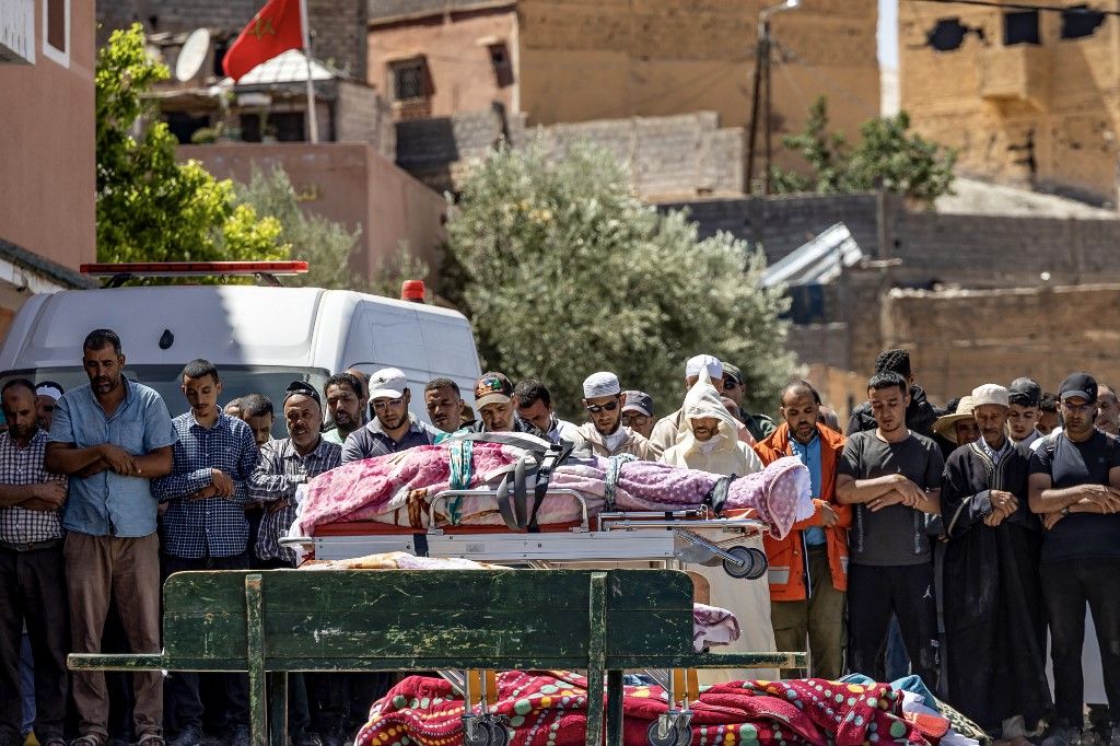 أشخاص يتلون الصلاة أمام جثث ضحايا الزلزال بمولاي إبراهيم ولاية الحوز، 9 سبتمبر 2023
