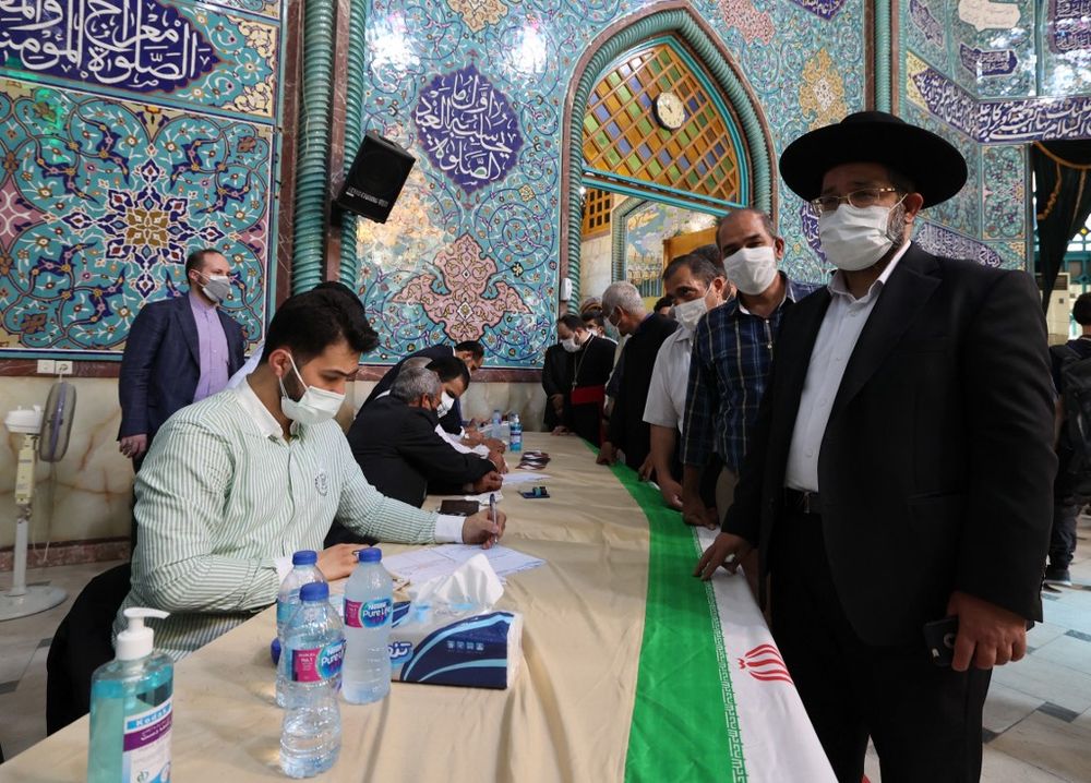 An Iranian Jewish man registers to vote at a polling station in the Hosseinyeh Ershad mosque in the capital Tehran during the country's presidential election.