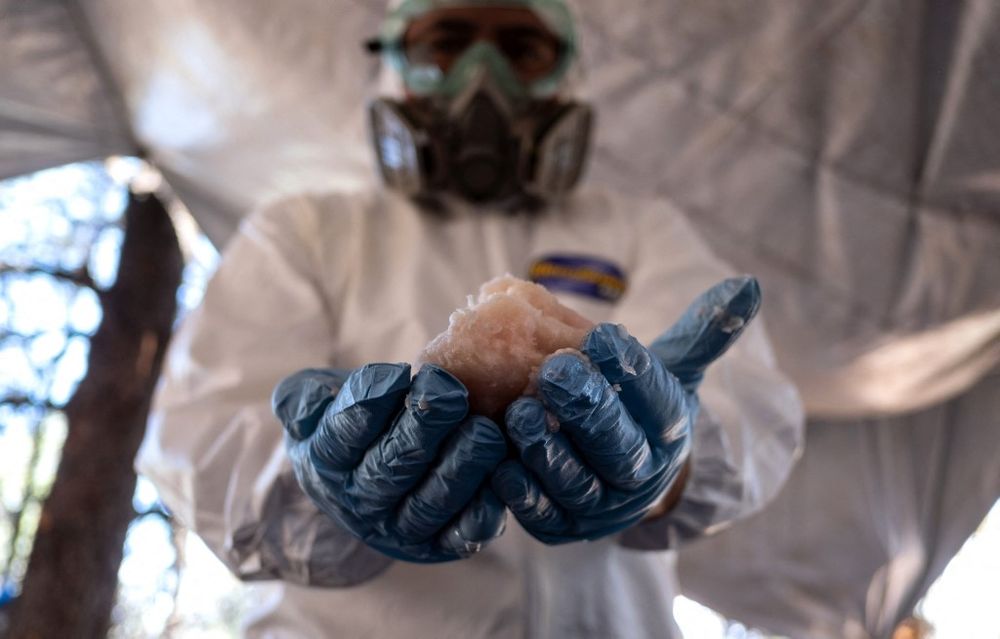 A Mexican Army expert shows crystal meth paste at a clandestine laboratory near the town of La Rumorosa in Tecate, Baja California state, in Mexico on August 28, 2018.