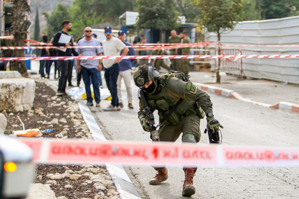 Israeli security and rescue personnel at the scene of a stabbing attack, at the entrance to Ariel Industrial zone, in the West Bank, on November 15, 2022.