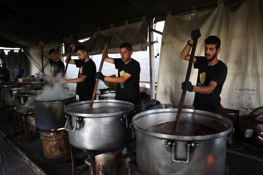 Local volunteers of the World Central Kitchen cook meals to be distributed to needy Palestinians in Rafah in the southern Gaza Strip