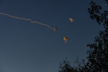 Smoke trails are seen as rockets launched from Lebanon into Northern Israel are intercepted by the Israeli Iron Dome.