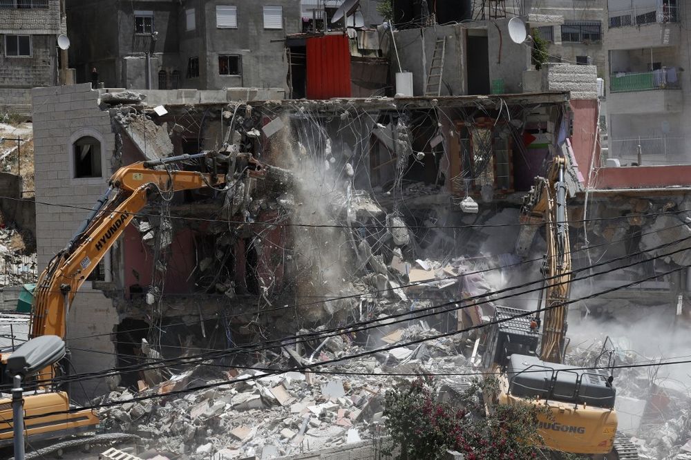 Israeli machinery demolish a Palestinian house in the Arab east Jerusalem neighborhood of Silwan on May 10, 2022.