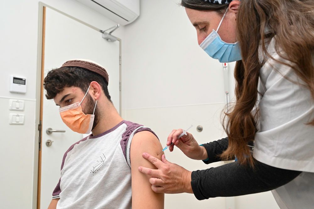 Israelis recieve a third dose of the Covid-19 vaccine at a health care center in Katzrin, Golan Heights, November 16, 2021.