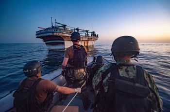A crew of the destroyer USS Winston S. Churchill operating under Combined Maritime Forces heads to provided assistance to an Iranian-flagged motor vessel in distress in the Gulf water off Oman.