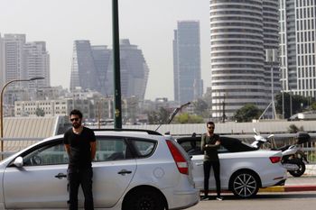 Israelis stand next to their cars as sirens mark a nationwide moment of silence in remembrance of the 6 million Jewish victims of the Holocaust, in Tel Aviv, Israel.