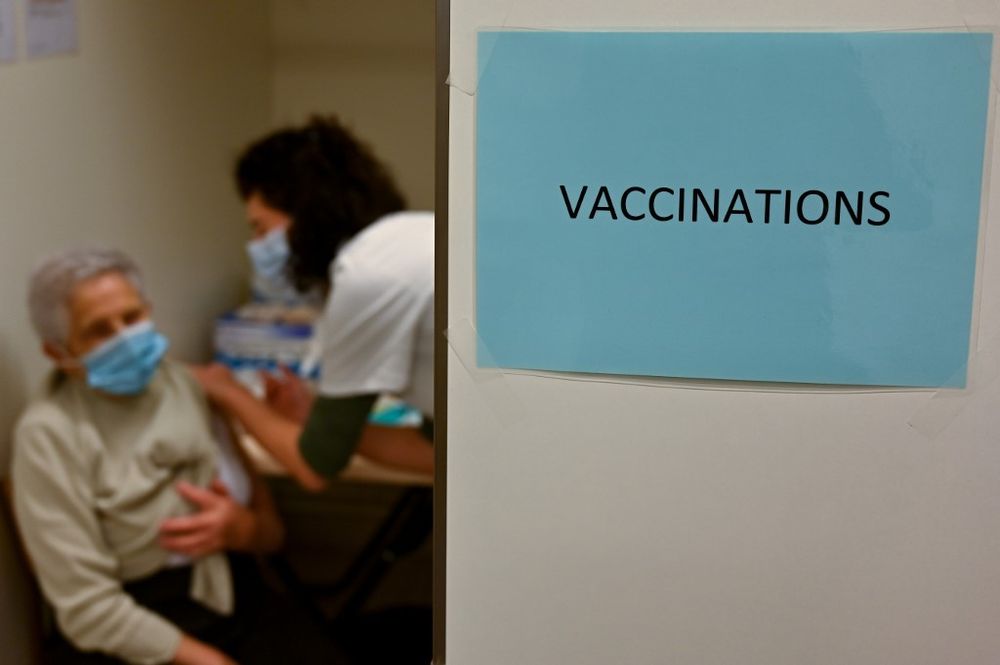An elderly woman receives a Pfizer-BioNTech Covid-19 vaccine on January 19, 2021.
