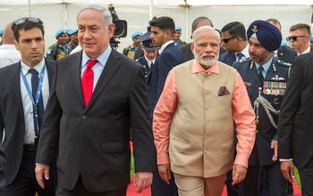 Indian Prime Minister Narendra Modi, center right, and Israeli Prime Minister Benjamin Netanyahu, center left, stand alongside an Indian army officer, as they honor fallen Indian soldiers, at the World War I Indian Army cemetery, in the Israeli coastal city of Haifa, Israel, Thursday, July 6, 2017