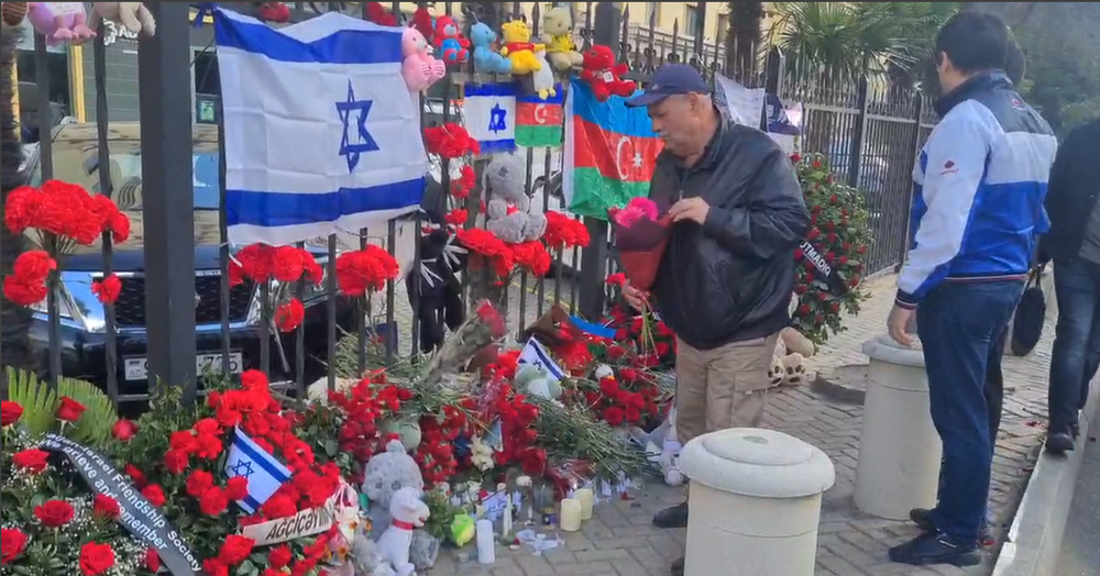 Azerbaijani lay wreaths, roses, and toys outside the Israeli embassy in Baku.