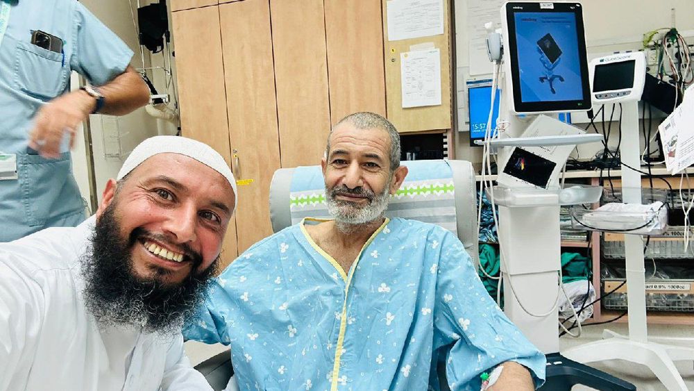 Qaid Farhan Alkadi (right) with his family after his rescue from Gaza