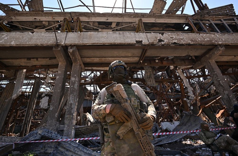 A Russian serviceman stands guard near the Azovstal steel plant in Mariupol, Ukraine, on June 13, 2022.