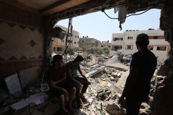 Palestinians inspect the damage to a house following the latest three days of conflict in Gaza City, Gaza, on August 8, 2022.