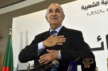 Algerian President-elect Abdelmadjid Tebboune greets attendees during a press conference in the capital Algiers, on December 13, 2019.