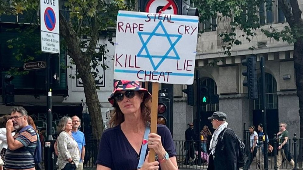 Photo from social media used in accordance with Clause 27a of the Copyright Law A protester for the proscribed group Palestine Action holding up a banner with the Star of David and derogatory messages
