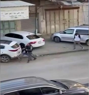 Israeli border guard grappling with a Palestinian assailant who's trying to seize his automatic weapon.