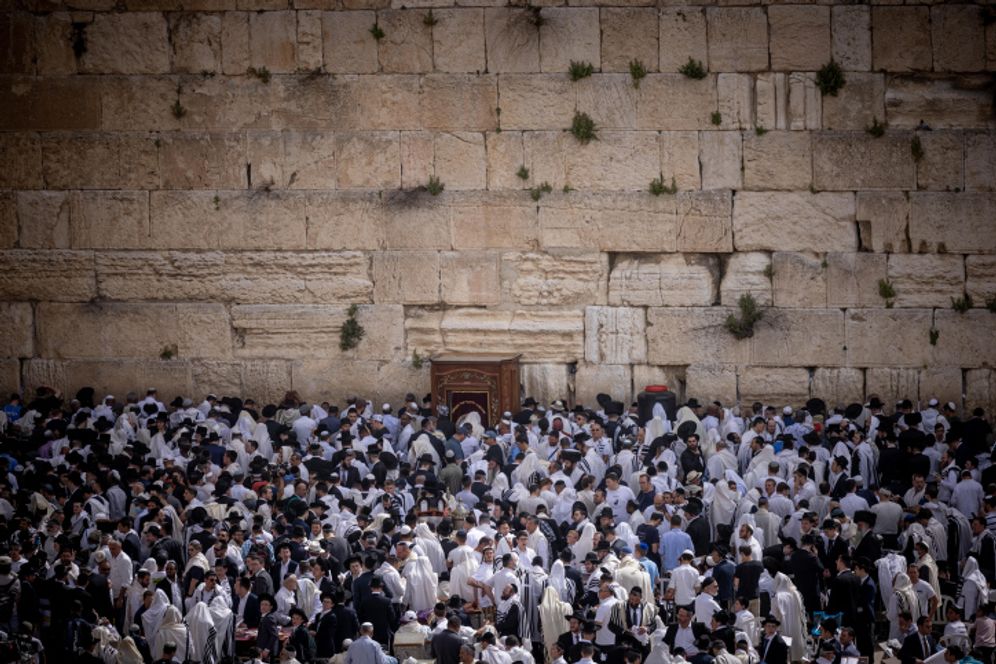 Jewish worshippers cover themselves with prayer shawls as they pray in front of the Western Wall, Judaism's holiest prayer site, in Jerusalem's Old City.