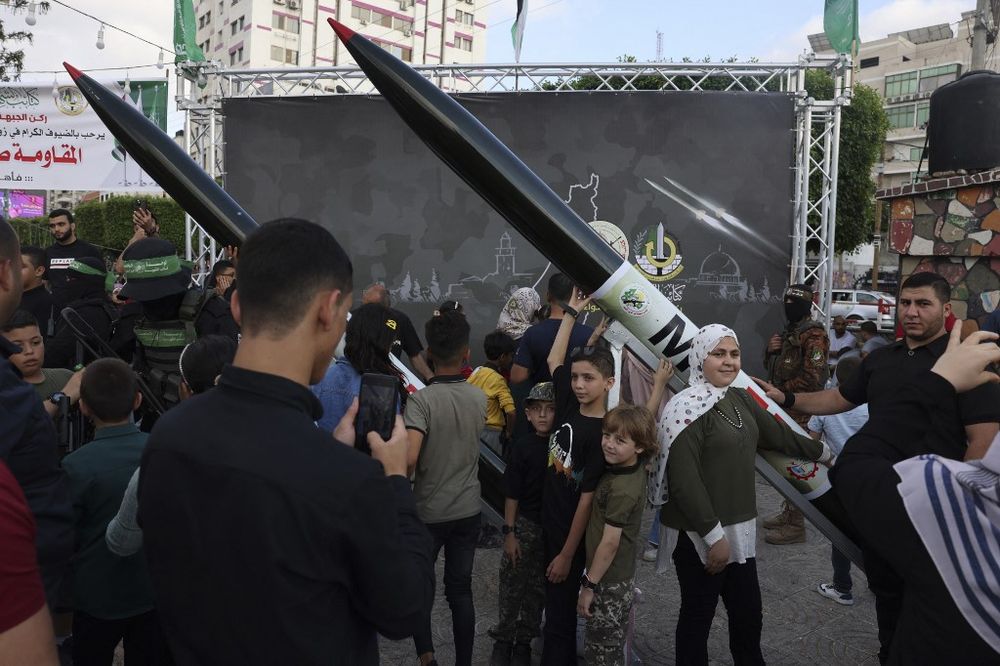 A Palestinian poses for a souvenir picture with an RPG launcher during an exhibition by the Ezzedine al-Qassam Brigades, the military wing of the Hamas movement, in Gaza City.