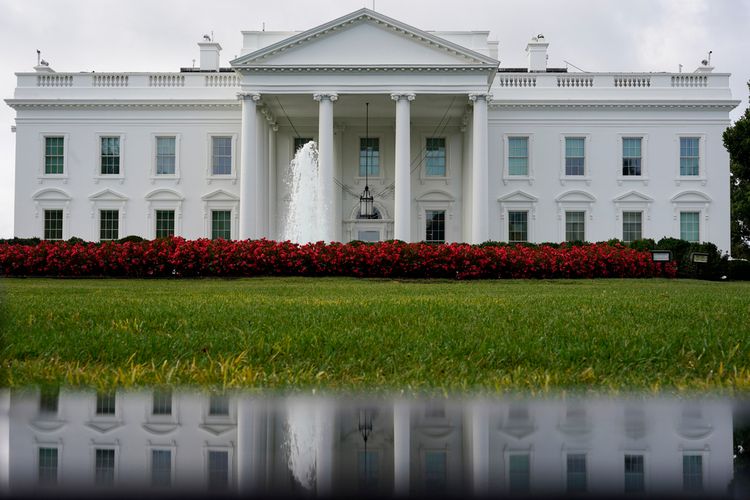FILE - The White House is seen reflected in a puddle, Saturday, September 3, 2022, in Washington.