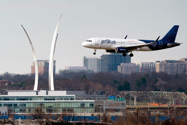 Passenger flights land and take off at Reagan Washington National Airport in Arlington, Virginia, across the Potomac River from Washington, January 19, 2022.
