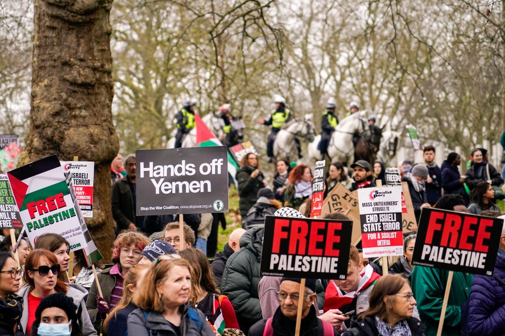 Protesters hold up flags and placards during a demonstration in support of Palestinian people in Gaza, in London, Saturday, Feb. 17, 2024.