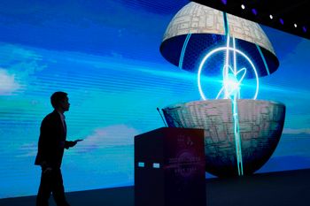 A speaker walks to the podium during a session for the 2023 World Artificial Intelligence Conference held in Shanghai, China.