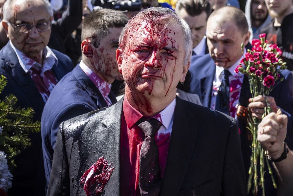 Sergey Andreev, the Russian Ambassador to Poland, reacts after being covered with red paint in Warsaw, Poland, on May 9, 2022.