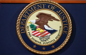 The Department of Justice seal is seen on a lectern ahead of a press conference at the Department of Justice in Washington, DC on November 28, 2018.