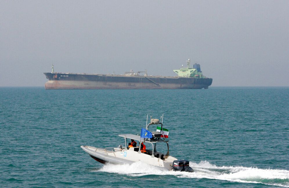 FILE - In this July 2, 2012 file photo, an Iranian Revolutionary Guard speedboat moves in the Persian Gulf near an oil tanker.